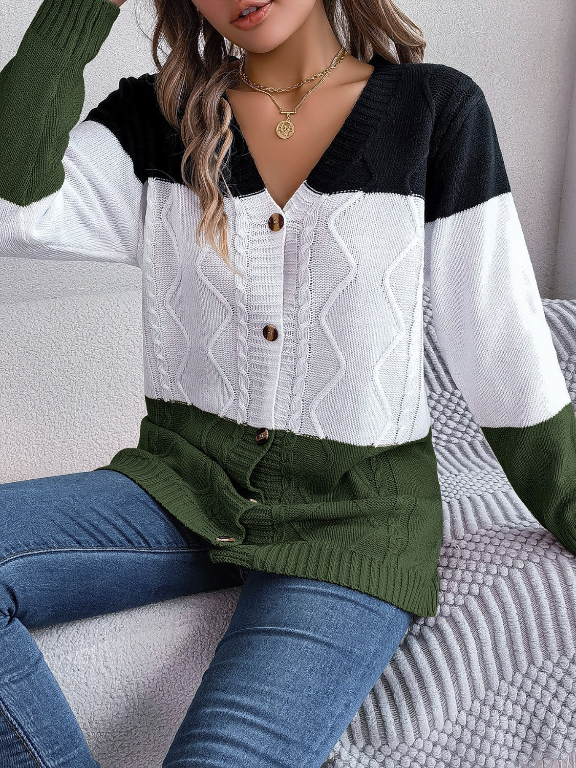 Colorblock cable knit cardigan with button front and v-neck in acrylic.