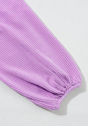 Lilac textured blouse with subtle stripe pattern and gathered balloon sleeve.