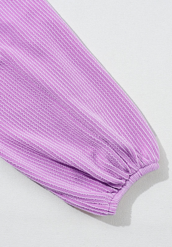 Lilac textured blouse with subtle stripe pattern and gathered balloon sleeve.