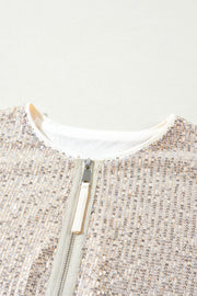 Sequin bomber jacket in cream with ribbed trim and silver zipper detail.