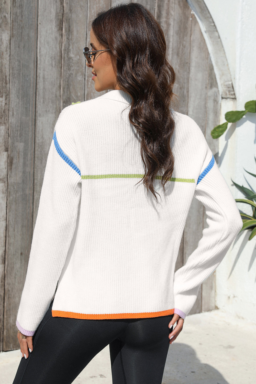 White ribbed quarter-zip pullover sweater with colorblock stripes on sleeves and hem.
