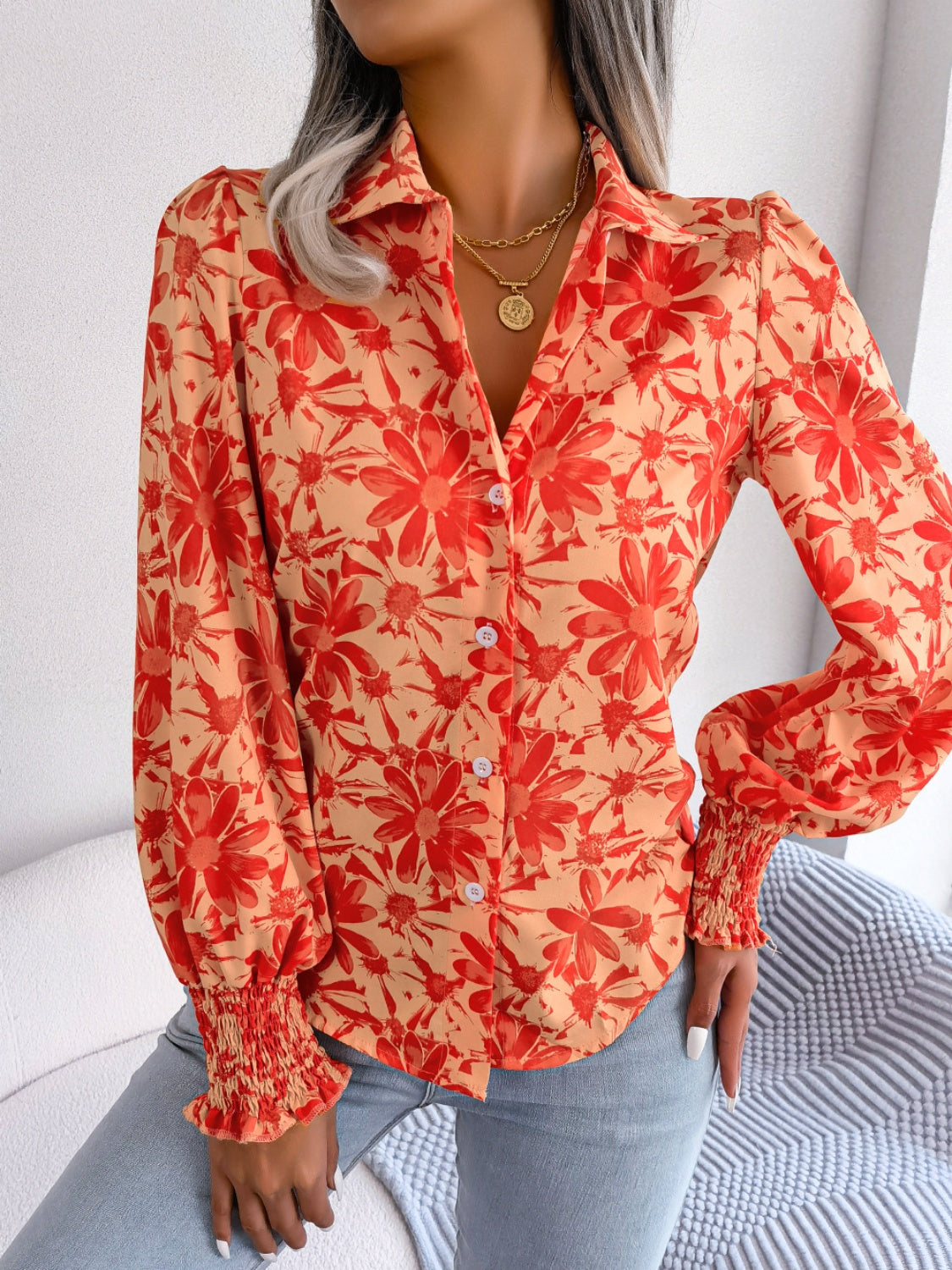 Floral print shirred cuff blouse in pumpkin with button front and collared neckline.