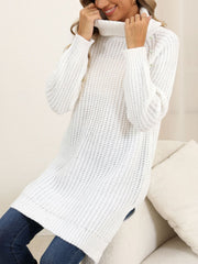 White ribbed turtleneck tunic with pearl embellishments on the shoulder.