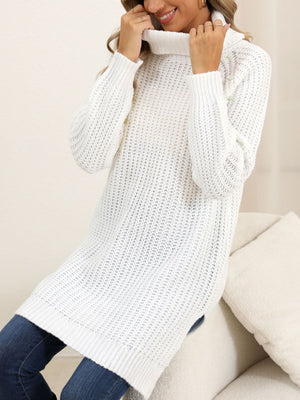 White ribbed turtleneck tunic with pearl embellishments on the shoulder.