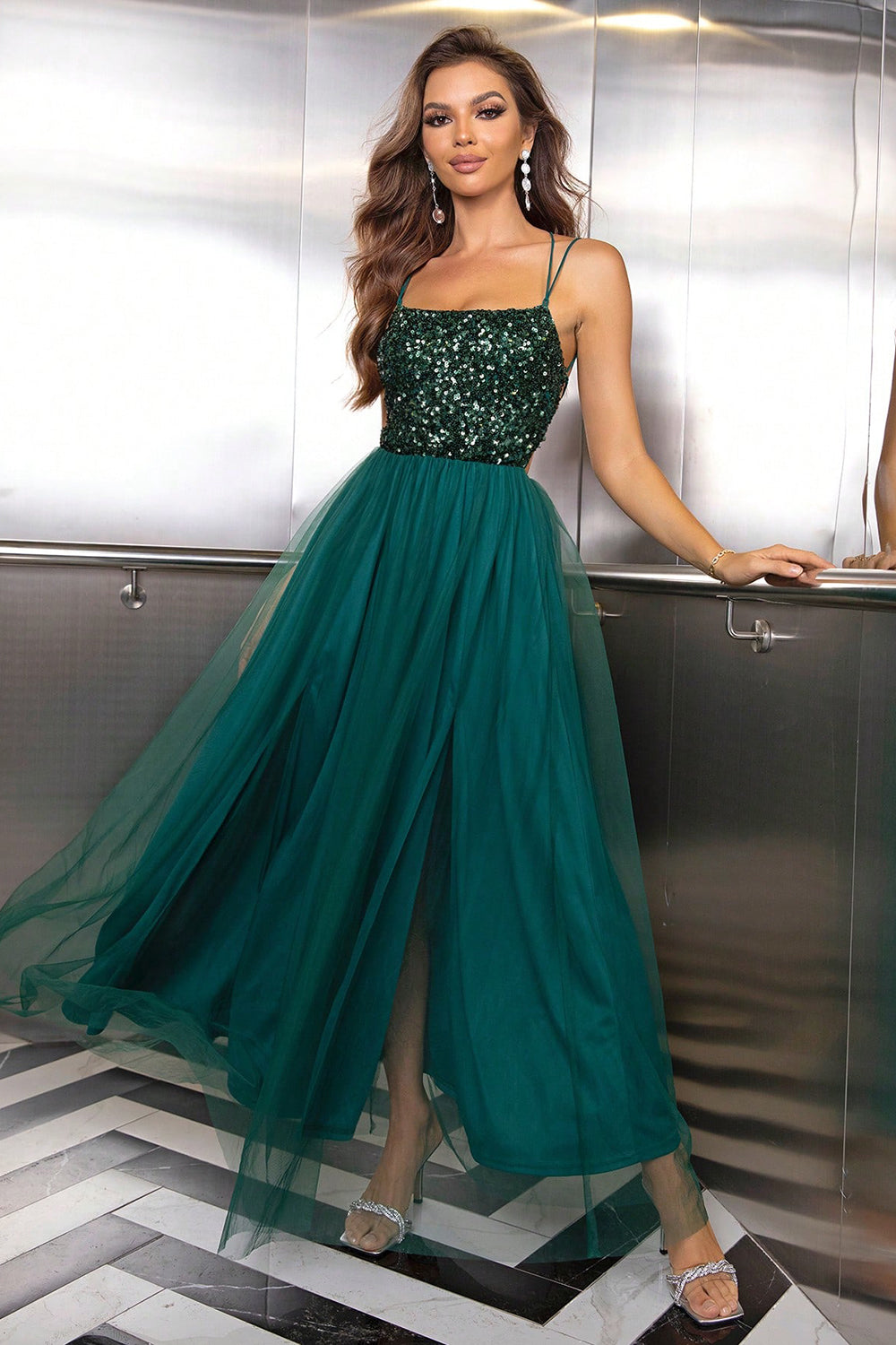 Green sequin bodice tulle maxi dress with spaghetti straps and a high slit.