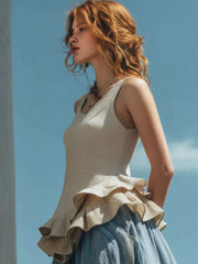 Off-white sleeveless tank top with tiered ruffled hem detail.
