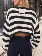 Off-shoulder cropped stripe knit sweater in black and white acrylic with a ribbed detail on the back.