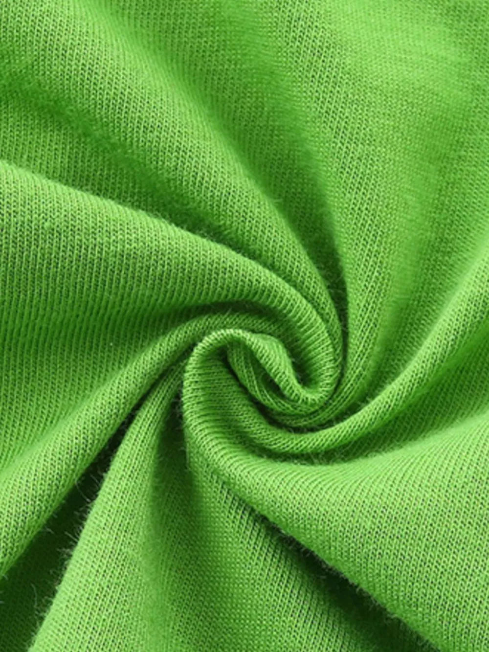 Green cotton fabric detail of baby tee and shorts set.
