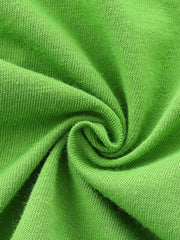 Green cotton fabric detail of baby tee and shorts set.