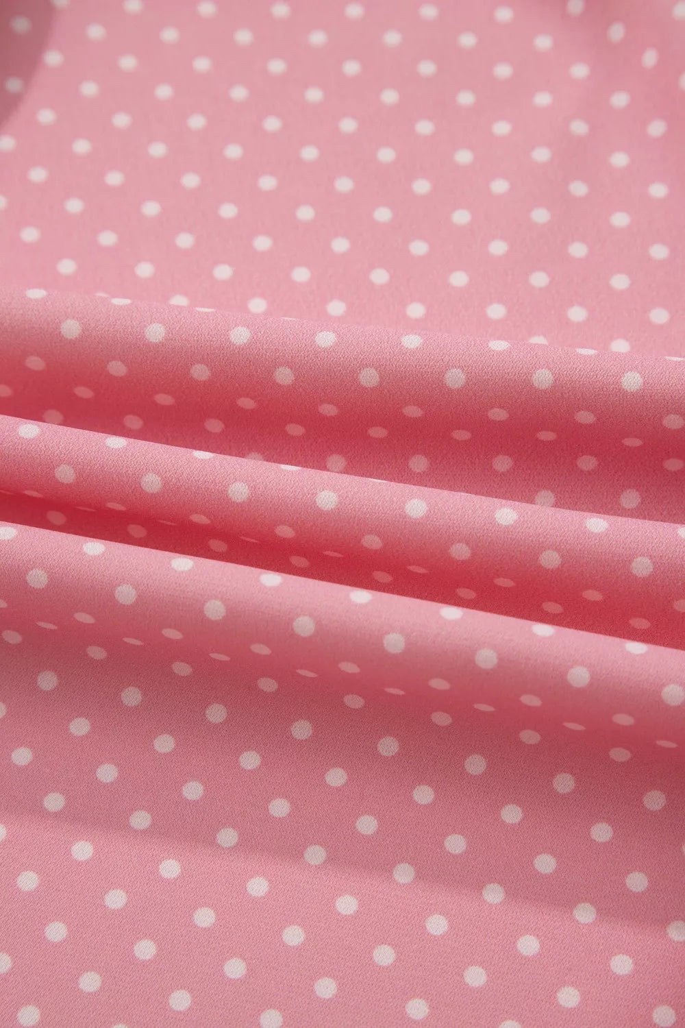 Pink polyester blouse with white polka dots