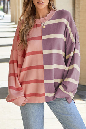 Colorblock stripe knit pullover sweater with crew neck and long sleeves.
