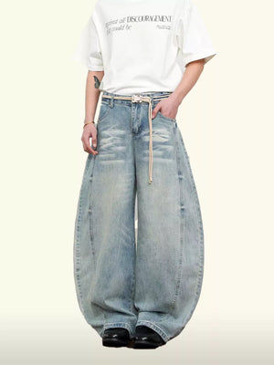Belted wide leg denim jeans in light blue with a balloon silhouette and 100% cotton fabric.