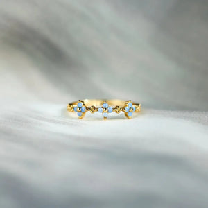 Gold band ring with blue floral accents and beaded details