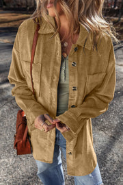 Camel corduroy overshirt with button cuffs and chest pockets, styled open over a henley.