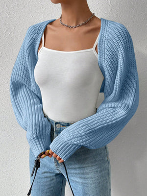 Light blue acrylic knit bolero shrug with wide sleeves and ribbed texture.