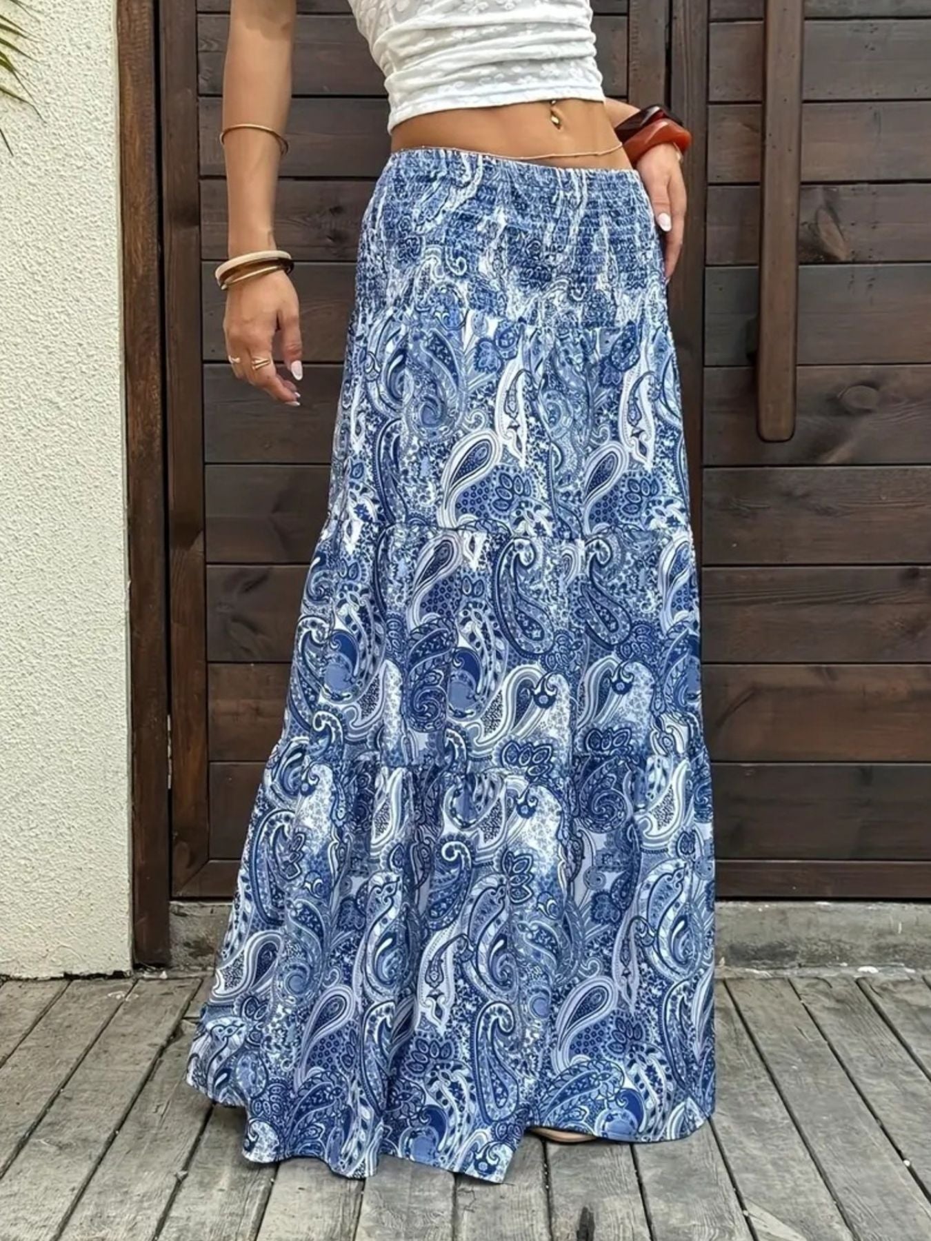 Bohemian paisley maxi skirt in blue with tiered ruffle hem and smocked waist.