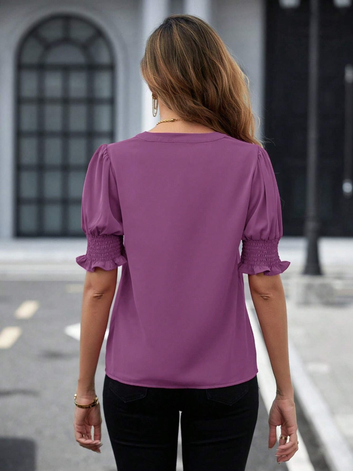 Mauve shirred sleeve blouse with puff sleeves and ruffled cuffs, showing the back view.