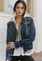 Hybrid denim jacket with grey hooded layer, distressed details, and zip front.