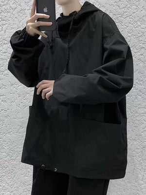 Black oversized drawstring hoodie with front pockets and cinched cuffs.