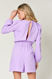 Lavender romper with puff sleeves, elastic waist, and open back detail.
