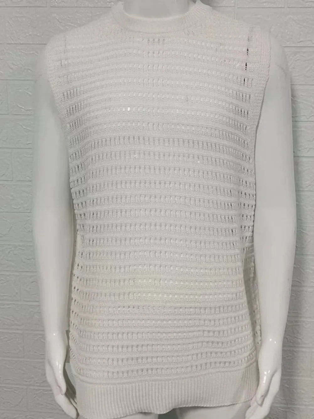 Ivory openwork knit tank top with a mock neck and ribbed hem.
