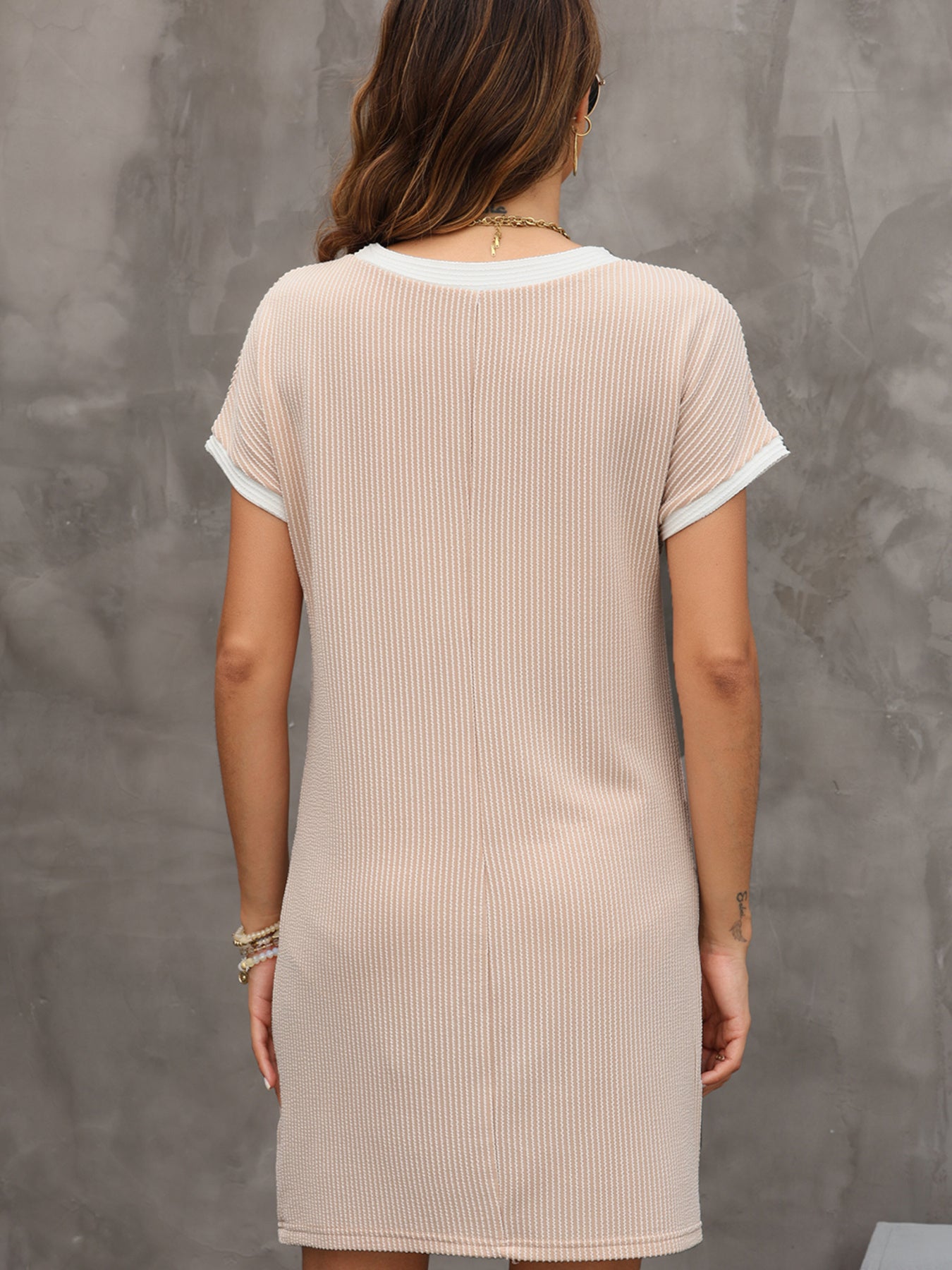 Beige t-shirt dress with crew neck, short sleeves, and above-knee length.