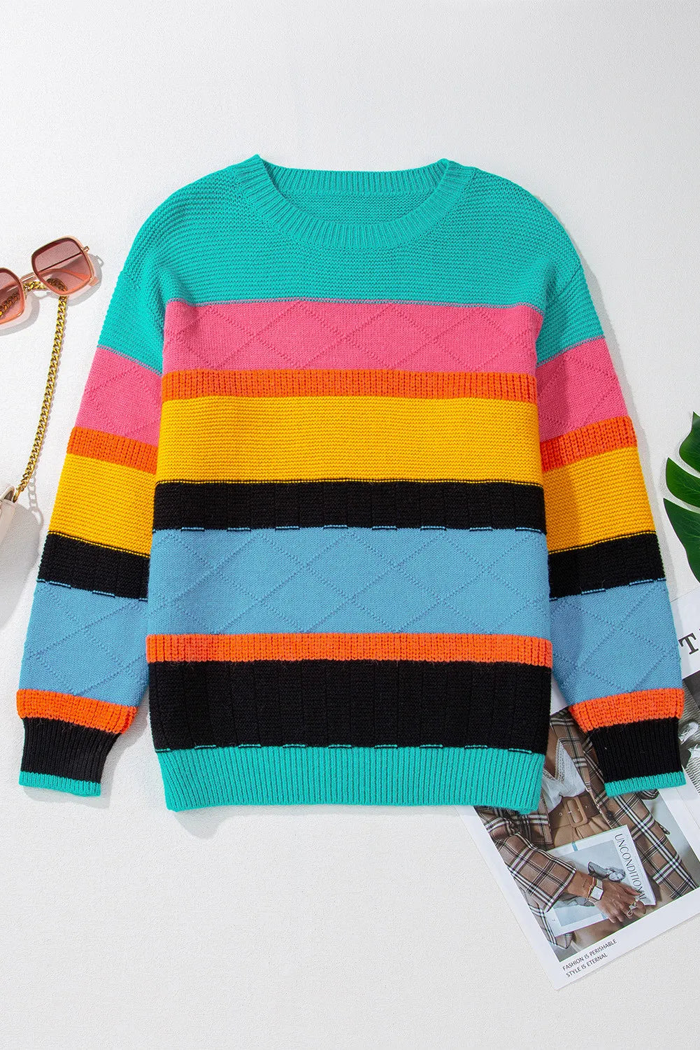 Rainbow stripe knit crewneck sweater with diamond pattern in turquoise, pink, yellow, black, and blue.