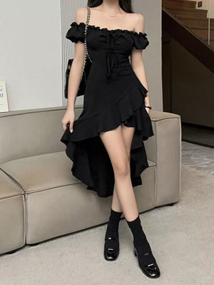 Black off-shoulder dress with ruffled asymmetrical hem and tie front.