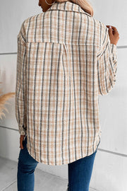 Textured tweed shirt jacket in tan with plaid pattern and buttoned front.
