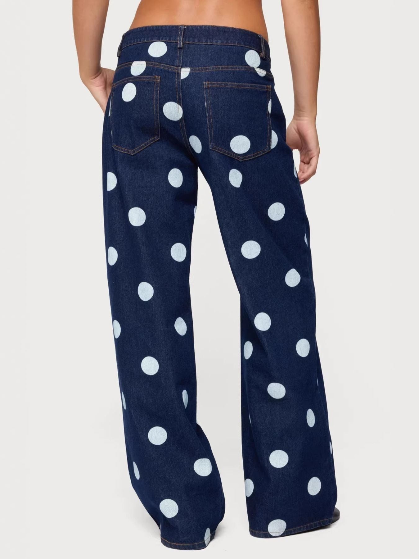Polka dot wide leg denim jeans with buttoned fly and back pockets.