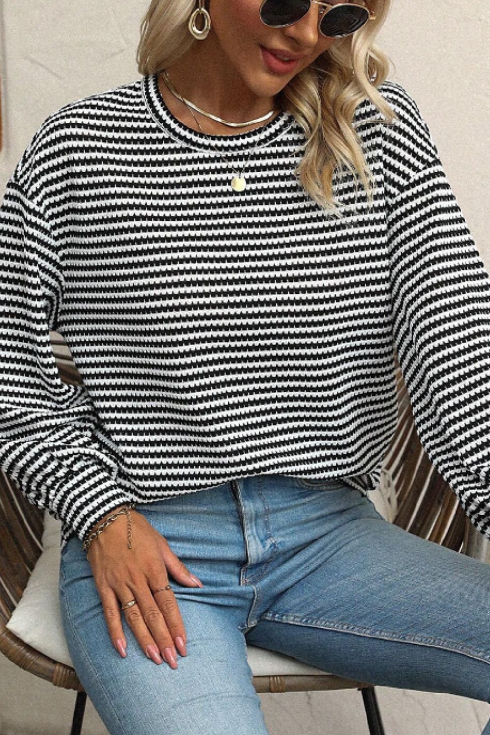 Textured stripe balloon sleeve top in black and white, with a crew neck and casual fit.