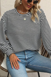 Textured stripe balloon sleeve top in black and white, with a crew neck and casual fit.