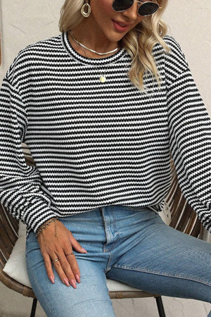 Textured stripe balloon sleeve top in black and white, with a crew neck and casual fit.