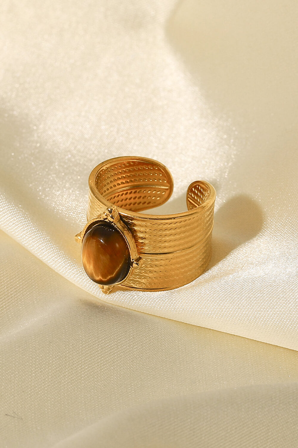 Textured gold cuff ring with brown tiger's eye stone, boho style.
