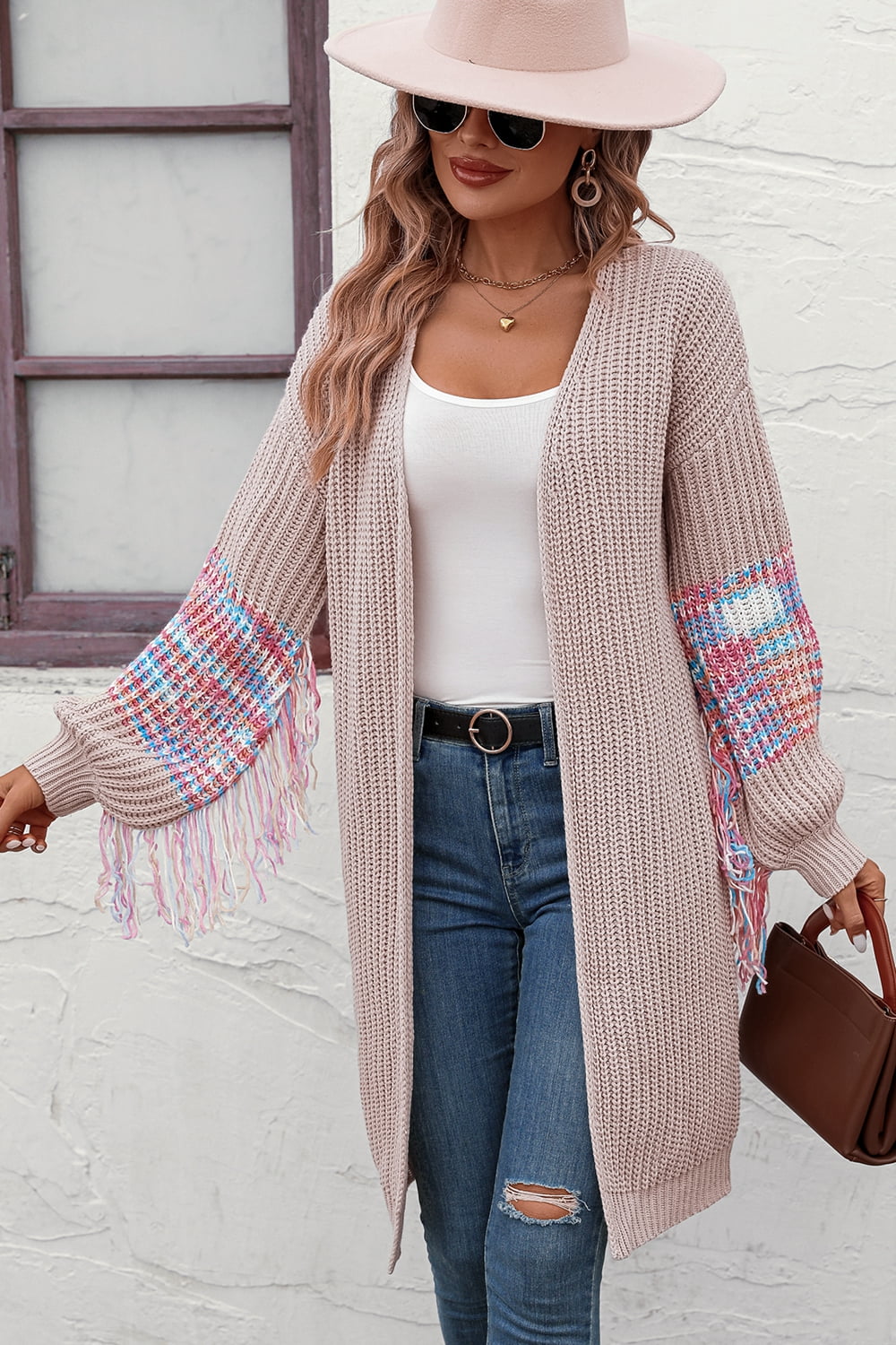 Textured sleeve fringe cardigan in acrylic with colorful sleeve detail and fringe.