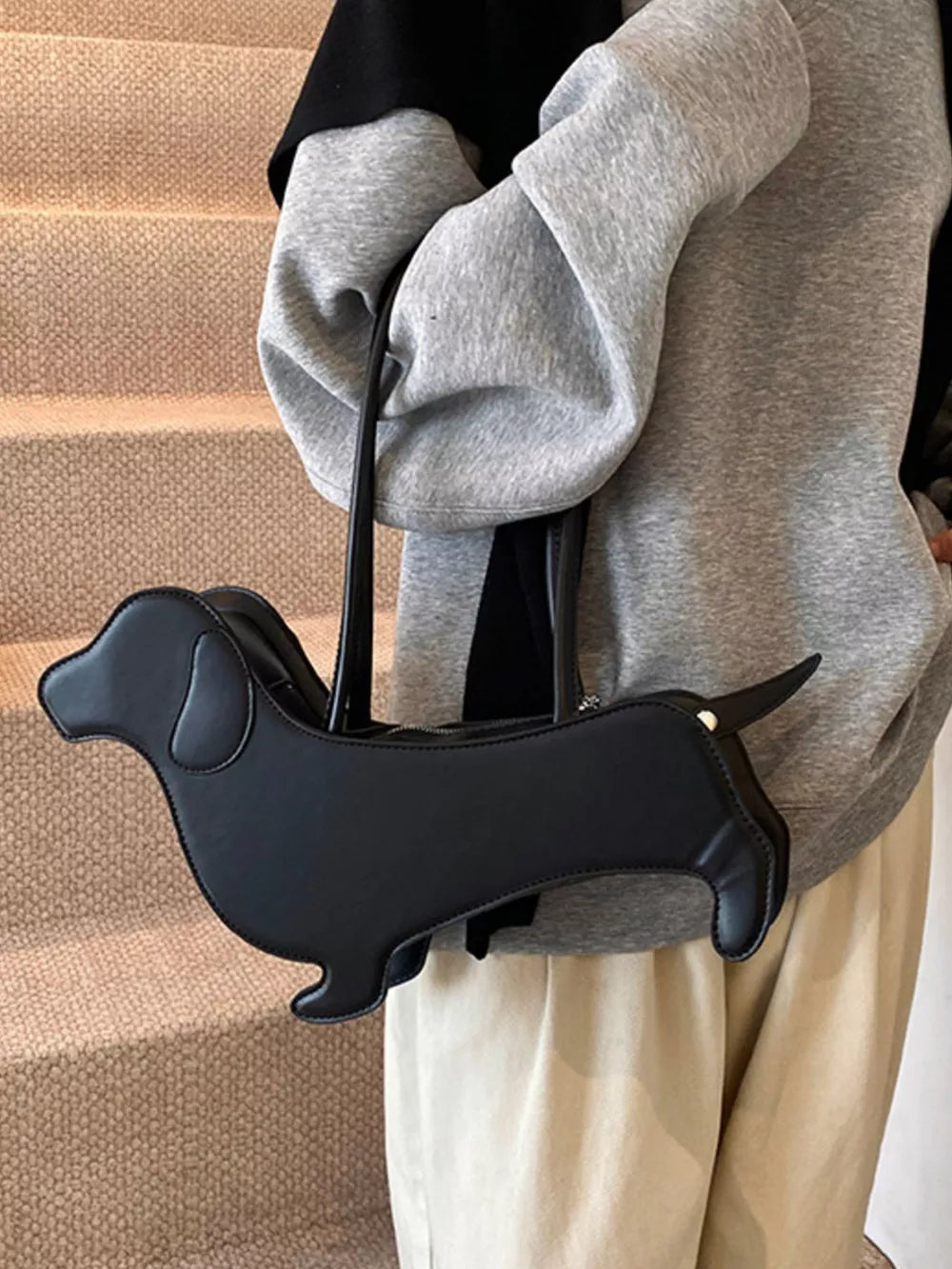 Black PU leather dachshund shoulder bag with zipper closure and top handles.