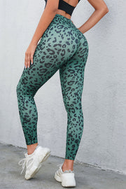 Turquoise leopard print performance leggings with a high waist.