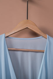 Sky blue mini dress with V-neck and ruffled detail.