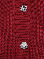 Red acrylic knit cardigan with pearl and rhinestone flower embellishments.