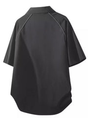 Black oversized button-front shirt with short sleeves and piped seams.