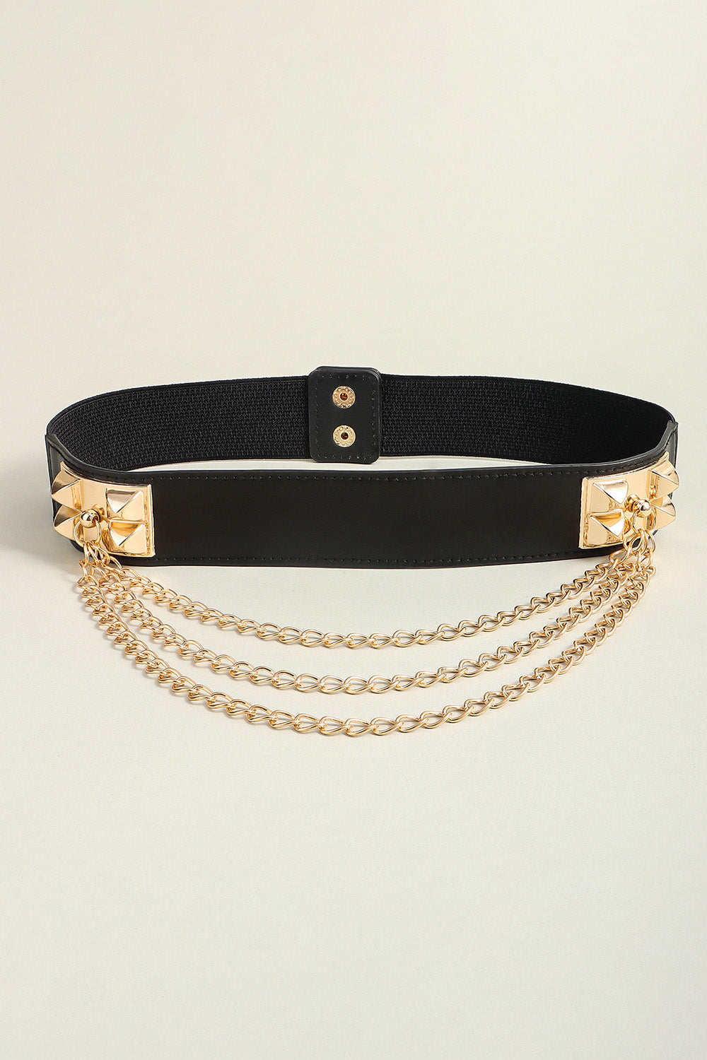 Black elastic belt with gold spiked studs and triple chain drape detail.
