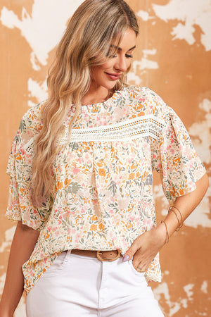Floral ruffle trim blouse with lace detail and short sleeves.
