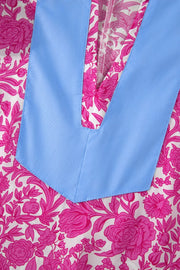 Vibrant floral midi dress with pink flowers on white, featuring a blue V-neck detail and ruffle sleeves.