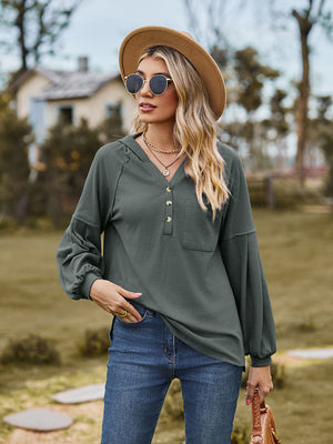 Army green ribbed henley hoodie with balloon sleeves and buttoned neckline.