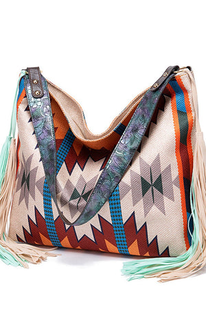Southwestern hobo bag with geometric pattern, canvas material, and fringe details.