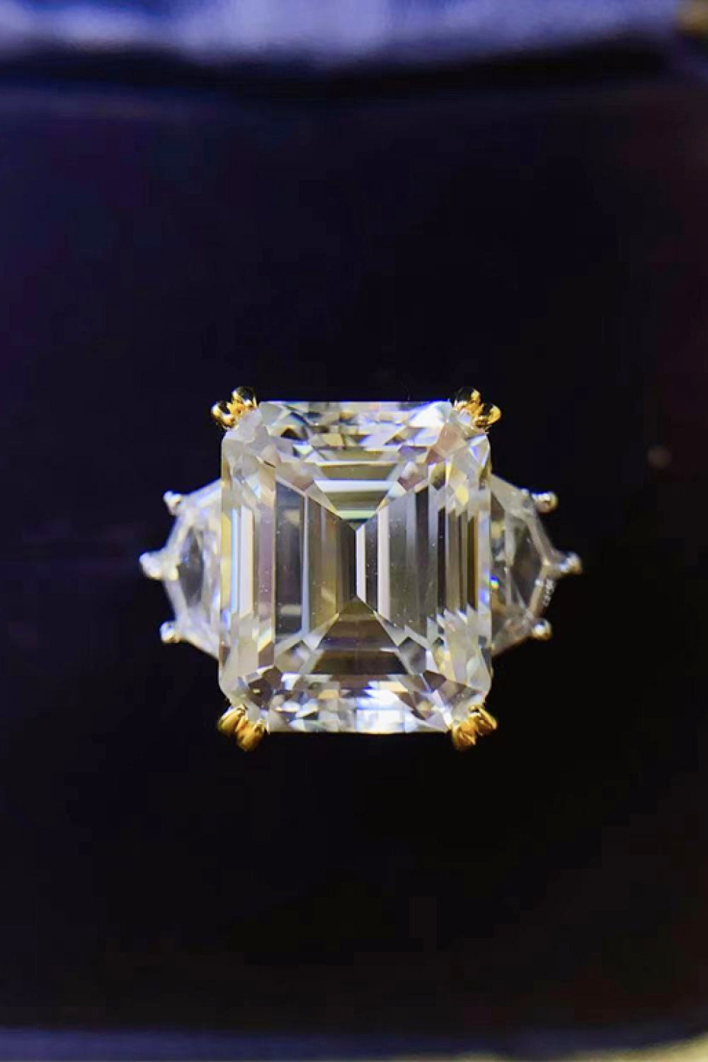 Emerald cut trilogy ring in silver with gold accents and clear stones