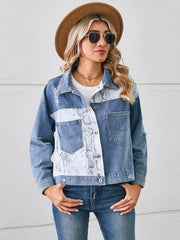 Denim trucker jacket with python pattern panel, distressed details, and chest pockets.