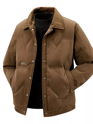 Brown padded puffer jacket with button-down front and collar, worn over a black turtleneck.