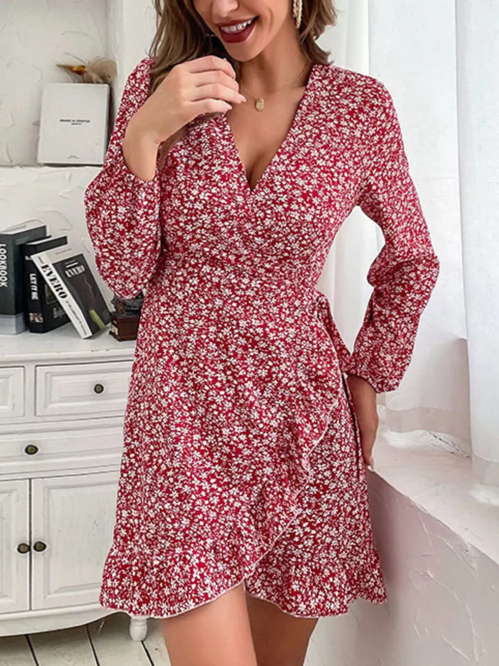 Red floral wrap mini dress with V-neck, long sleeves, and ruffled hem.