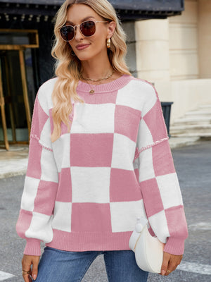 Checkerboard knit sweater in blush pink and white with balloon sleeves and crew neck.